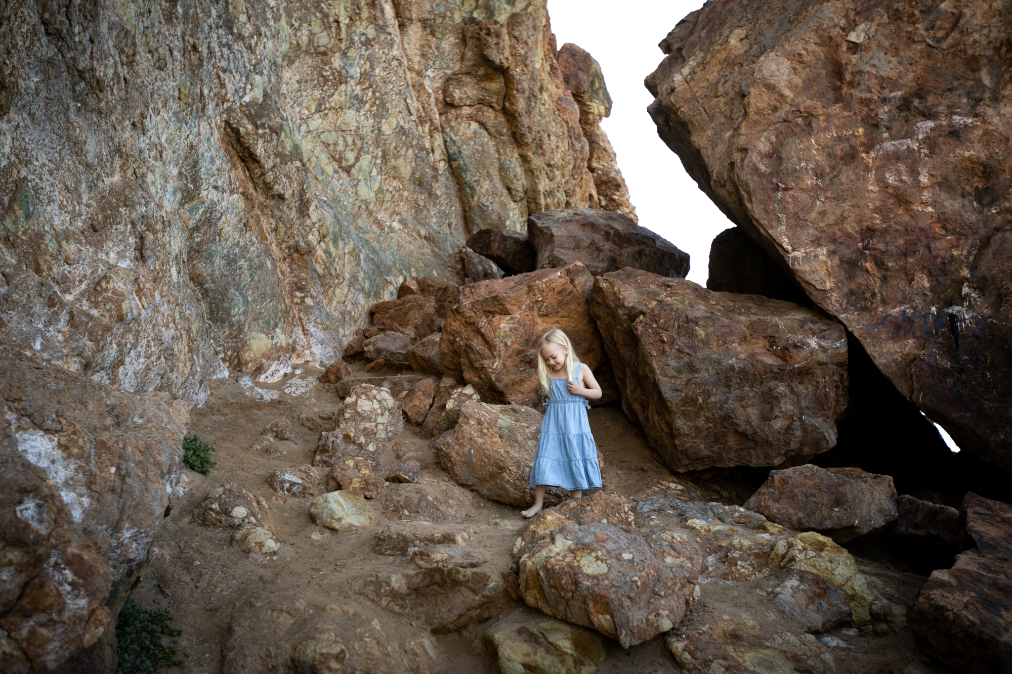 little girl plays on the rocks at Leo Carrillo State Beach